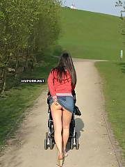 Beautiful brunette young MILF walking in the streets and public places with no panties upskirt, see how she flashes her puffy lipped twat