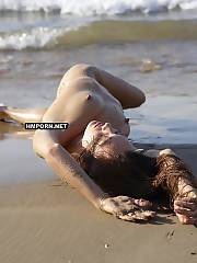 Slender nudist chick walks naked on the desert beach, lays on the sand and shows big lipped pussy, sexy legs and feet, round ideal ass, small but nicely nippled breasts and more