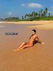 Smoking sexy ukrainian babe posing naked with AK-47 on the sandy beach at the Black Sea and shows her great naked body with huge natural tits, ideal butt and long sexy legs