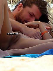 Amateur nudist couple caught sunbathing nude on the public beach, see beaitiful twat of blond girlie between wide spreaded legs - voyeur sex photos