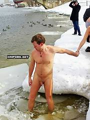 Crazy russians swim in cold water during the winter days, fine tradition of Epiphany religious holiday, watch nudists and naturist men and women swmming nude in ice hole