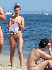 Amateur nudist and naturist couples sunbathing nude on the beach, sexy women walking nude and flashing their tits, butts and cunts, sunbathing with wide spreaded legs and getting filmed by horny voyeurists