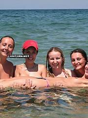 Nudist beach girls sunbathing naked at the sea and teasing strangers by wide spreaded legs and lovely vaginas without panties for fine tan