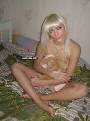 Skinny russian light haired chick posing naked on the bed, showing her long legs and hot feet, small melons but round ass and creamy vagina