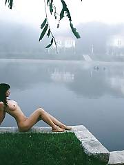 Asian babe posing naked outdoor.