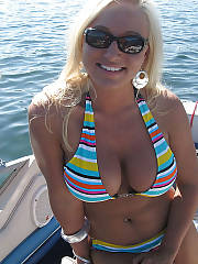 Sexy boobed blond showing breasts on the boat.
