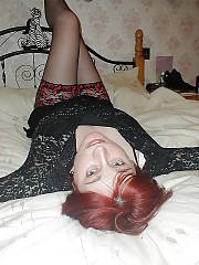 Gorgeous red-haired mamma in stockings loves fondling her pussy.