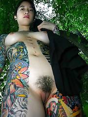 Hot tattooed asian exgirlfriend gets naked and wanks her hairy vagina in the forest.