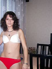 Black haired amateur teen teasing herself at home.