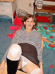 Mom shows off her hot legs clad in white stockings and rich leather boots.