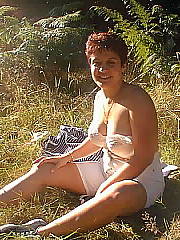 My mother sunbathing out in a field behind our flat. i fantasy about those boobs all the time...